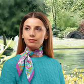 Woman wearing a floral blossom silk twill scarf with a scenic background of a pond and bridge.